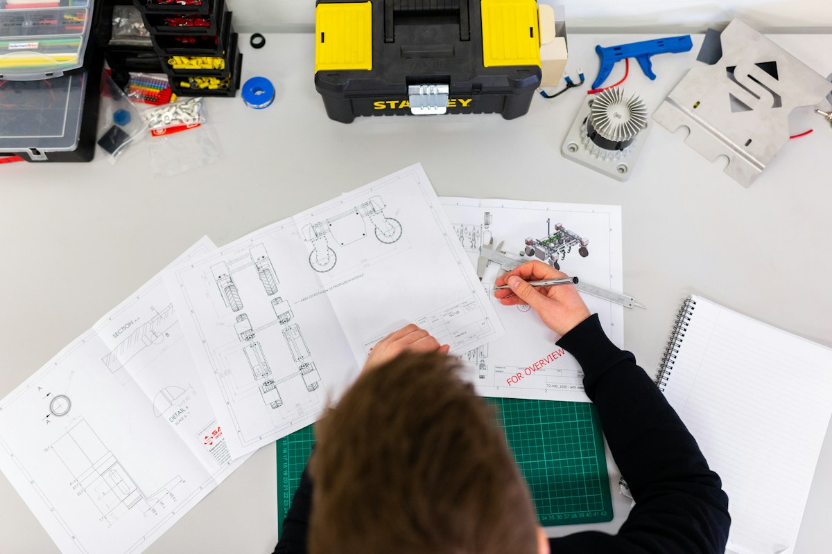 Engineer sketching mechanical design drawings